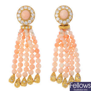 A pair of diamond and coral clip earrings.