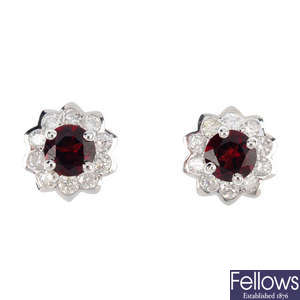 A pair of garnet and diamond cluster earrings.