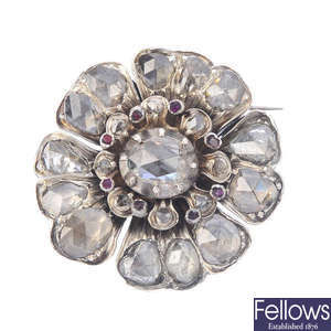 A foil-backed diamond flower brooch.