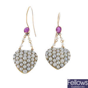 A pair of pearl heart earrings.
