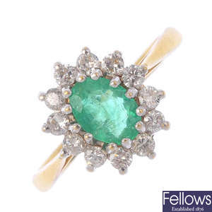 An 18ct gold emerald and diamond cluster ring. 