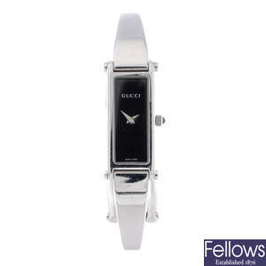 GUCCI - a lady's stainless steel 1500L bangle watch.