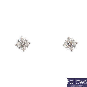 TIFFANY & CO. - a pair of brilliant-cut diamond stud earrings.