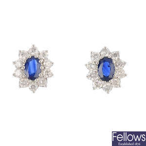 A pair of sapphire and diamond cluster earrings.