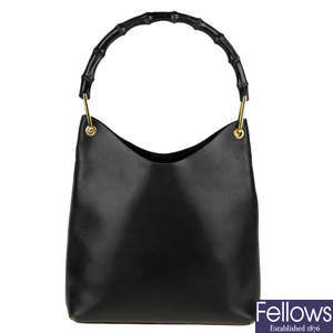 GUCCI - a black leather bamboo handbag with pouch.