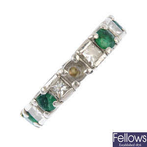 An emerald and diamond full-circle eternity ring. 