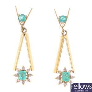 A pair of emerald and diamond earrings.