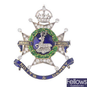 An early 20th century silver and gold diamond and enamel Regimental brooch.