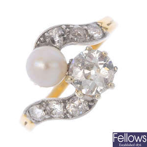 An early 20th century platinum and 18ct gold diamond and pearl crossover ring.