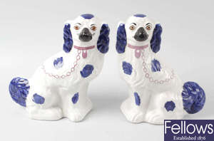 A box containing a pair of Staffordshire style pottery flat back fireside spaniels, another similar example and a Staffordshire pottery flat back figure group.