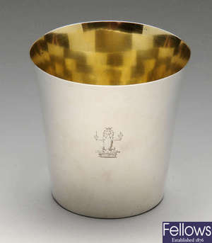 A George III plain silver beaker with crest engraving.