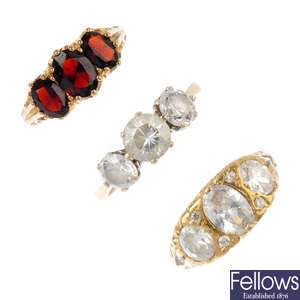 Five gem-set rings and a pair of earrings.
