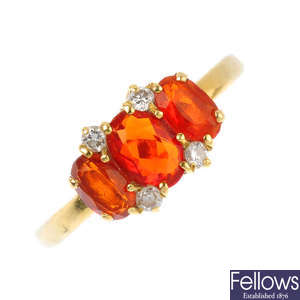 An 18ct gold fire opal three-stone and diamond ring.