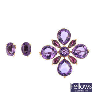 A garnet and amethyst brooch and a pair of amethyst earrings.