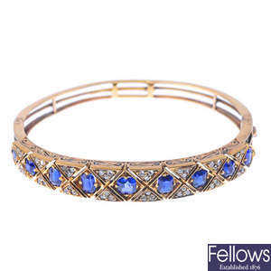 An early 20th century gold, sapphire and diamond hinged bangle.