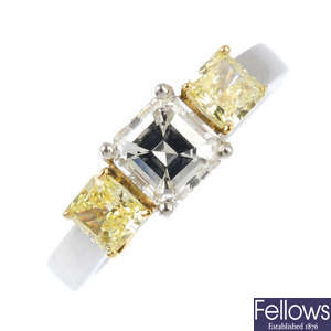 A platinum diamond and 'yellow' diamond three-stone ring.