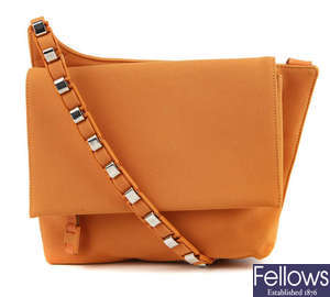 SALVATORE FERRAGAMO - an orange asymmetric handbag.