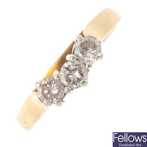 A diamond three-stone shaped band ring.