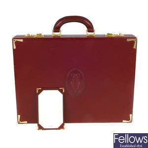 CARTIER - a 1980s Must De Cartier Bordeaux briefcase with writing pad and paper.
