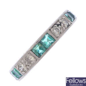 An emerald and diamond eternity ring.