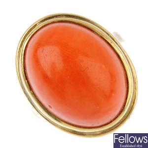 A coral single-stone ring. 