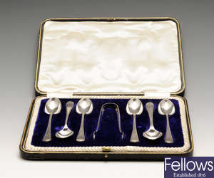 Three 20th century cased sets of silver spoons to include enamelled examples.