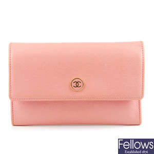 CHANEL - a pink purse.