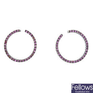 A pair of sapphire hoop earrings.