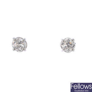 A pair of platinum diamond stud earrings.