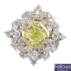 A Fancy Light Greenish Yellow diamond and diamond dress ring.