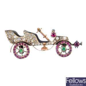 An early 20th century silver and gold, diamond and gem-set car brooch.