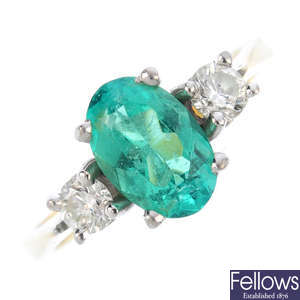 An 18ct gold emerald and diamond three-stone ring. 