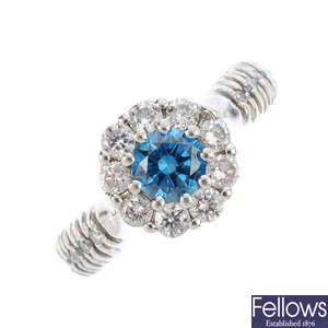 A colour treated 'blue' diamond and diamond cluster ring.