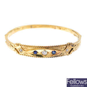 A late Victorian 15ct gold diamond and sapphire hinged bangle.