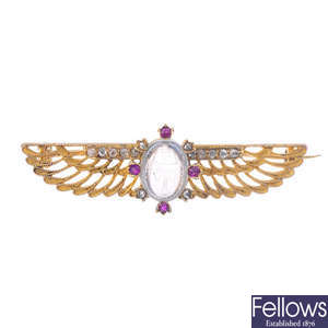 An early 20th century Egyptian Revival gold, diamond and gem-set brooch.