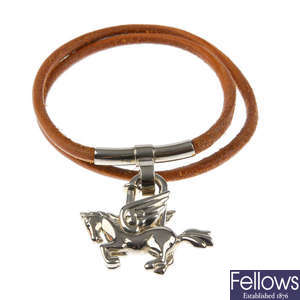 HERMÈS - a leather bracelet and Pegasus padlock.