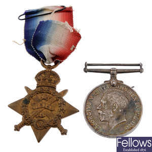 A selection of Great War medals & cap badges.