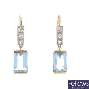 A pair of diamond and aquamarine earrings.
