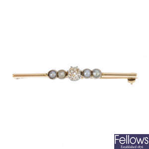 A split pearl and diamond brooch.