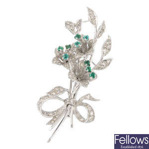 An emerald and diamond floral brooch.
