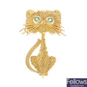 A 1970s 18ct gold and emerald cat brooch.