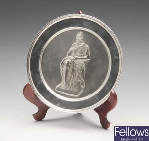 A modern silver plate with embossed figure of Moses.