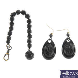 A pair of late Victorian jet earrings and a carved jet bead chain. 
