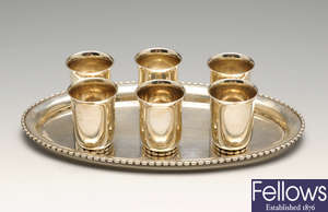 A Dutch small oval tray with beaded border and six matching tot cups & three bud vases.