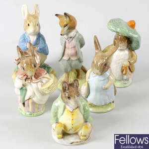 A large group of Beswick Beatrix Potter storybook figurines.