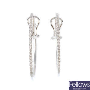 A pair of diamond hoop clip earrings.