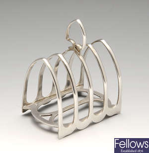 An Edwardian silver five bar toast rack, plus two further silver examples.