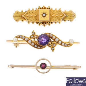 Three early 20th century gem-set brooches and a pair of gem-set earrings.