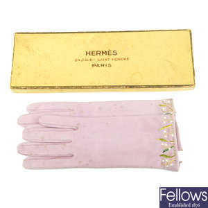 HERMÈS - a pair of 1950s embroidered leather gloves.