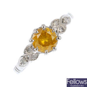 A Fancy vivid Orangy Yellow diamond and diamond dress ring.